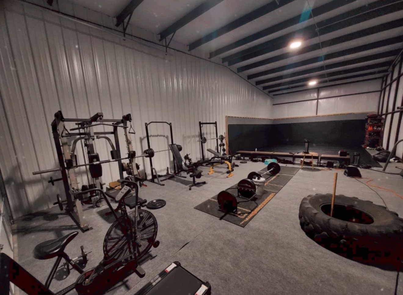 Doghouse MMA & Fitness facility interior showing training equipment and mats